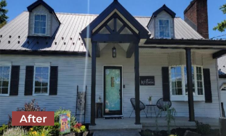 Home exterior after remodel with light siding, new front entrance, glass front door, and dark gray roofing.