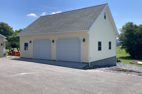 Light yellow and white pole barn garage.