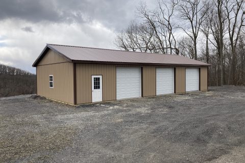 Brown and white pole barn garage.